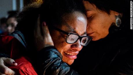 Isabel Kinnane Smith of Allderdice is comforted by Lesley Britton, a math teacher at the school, at a vigil blocks from where an active shooter shot multiple people at Tree of Life Congregation synagogue on Saturday, Oct. 27, 2018, in the Squirrel Hill section of Pittsburgh. (Stephanie Strasburg/Pittsburgh Post-Gazette via AP)
