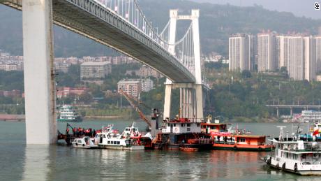 Rescuers conduct search and rescue operation at the site where a bus has plunged off a bridge into the Yangtze River in Wanzhou on October 28.