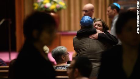 People of faith greet each other at Temple Sinai before Friday evening Shabbat services. 