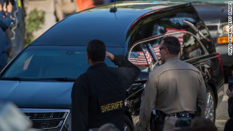 A car in a procession carries the body of Ventura County sheriff&#39;s Sgt. Ron Helus.