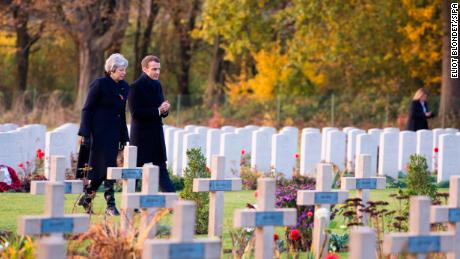 UK Prime Minister Theresa May talks with French President Emmanuel Macron at the Thiepval Memorial in northern France on Friday.