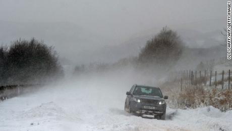 A car is driven along the A670 in snow near the village of Diggle, east of Manchester in northern England on March 18, 2018, as the wintry weather makes a return to the country.
The Met Office has weather warnings in place for the UK as some areas expect up to 25cm of snow to fall on Sunday. / AFP PHOTO / Oli SCARFF        (Photo credit should read OLI SCARFF/AFP/Getty Images)