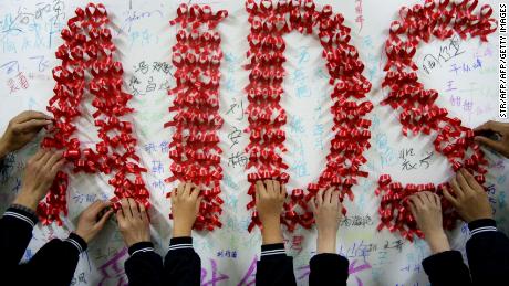 Chinese students use handmade red ribbons to form &quot;AIDS&quot; one day ahead of the the World AIDS Day, at a school in Hanshan, east China&#39;s Anhui province on November 30, 2009. China warned in a notice for  World AIDS Day that homosexual transmission of the disease was gaining pace and called for health authorities nationwide to step up prevention work. China&#39;s health ministry estimates that at the end of 2009, 740,000 people were living with HIV in the country of 1.3 billion, and the latest data shows that 48,000 were infected this year, according to UNAIDS.  CHINA OUT AFP PHOTO / AFP / STR        (Photo credit should read STR/AFP/Getty Images)