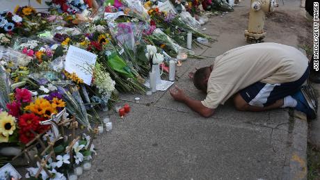A man prays at a memorial for the victims of Charleston.