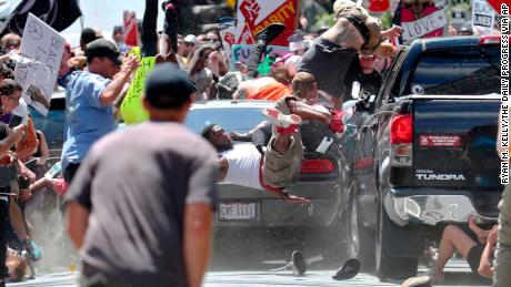 People are tossed into the air as a car enters a crowd demonstrating against the white nationalist rally in Charlottesville.
