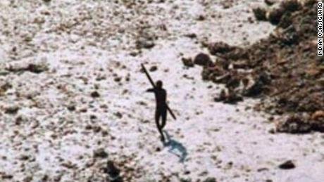 An image of a member of the Sentinel tribe aiming for a helicopter in 2004 after the tsunami in the Indian Ocean. 