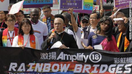 Members of a pro-gay Christian group gather for media before the start of the gay pride parade in Taipei on October 27, 2018.