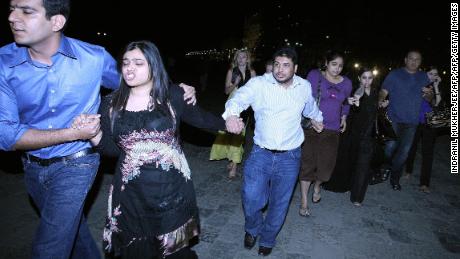 Indian and foreign guests rush out of the Taj Mahal hotel as news of the attack explodes. 
