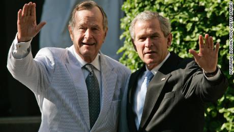 WASHINGTON - MAY 6:  U.S. President George W. Bush (R) and his father, former U.S. President George Bush (L) wave as the leave a family wedding at St. John&#39;s Episcopal Church May 6, 2006 in Washington, DC. Alexander Ellis, son of George W. Bush&#39;s cousin, married Sarah Aker.  (Photo by Normand Blouin/Pool/Getty Images)