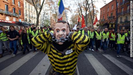 Demonstrators with the &quot;gilets jaunes&quot; or &quot;yellow vest&quot; movement call for the French President Emmanuel Macron to resign at a demonstration last month.