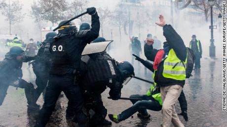 Protesters and riot police clash during the &quot;yellow vest&quot; protests in Paris on December 1. 