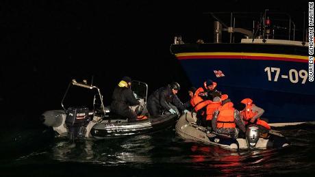 Iranian migrants traveling in a dinghy are picked up by a British lifeboat and French Maritime Police.