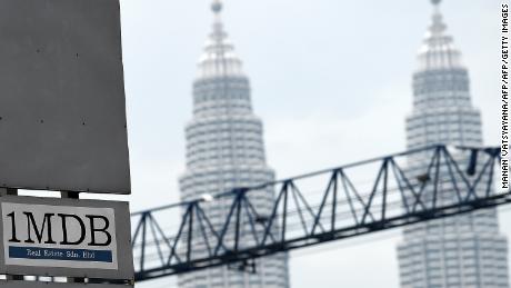 Malaysia&#39;s Twin towers form the backdrop for the 1Malaysia Development Berhad (1MDB) logo on a billboard.