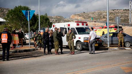 Israeli soldiers stand at the scene of an attack near the settlement of Givat Assaf in the West Bank on Thursday.
