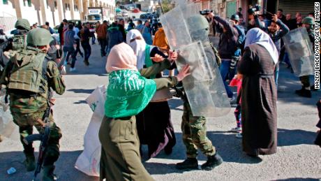 Palestinian security forces clash with Hamas supporters in Hebron on Friday.
