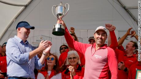 Wild Oats XI skipper Mark Richards holds the trophy aloft after taking a ninth line honors title in the 2018 Sydney to Hobart yacht race.