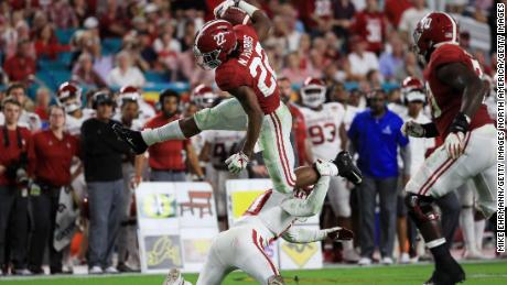 Najee Harris of the Alabama Crimson Tide carries the ball against the Oklahoma Sooners during the College Football Playoff Semifinal at the Capital One Orange Bowl.