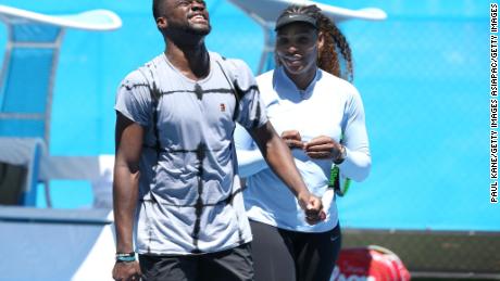 US&#39; Frances Tiafoe and Serena Williams share a moment on the practice court during day two.