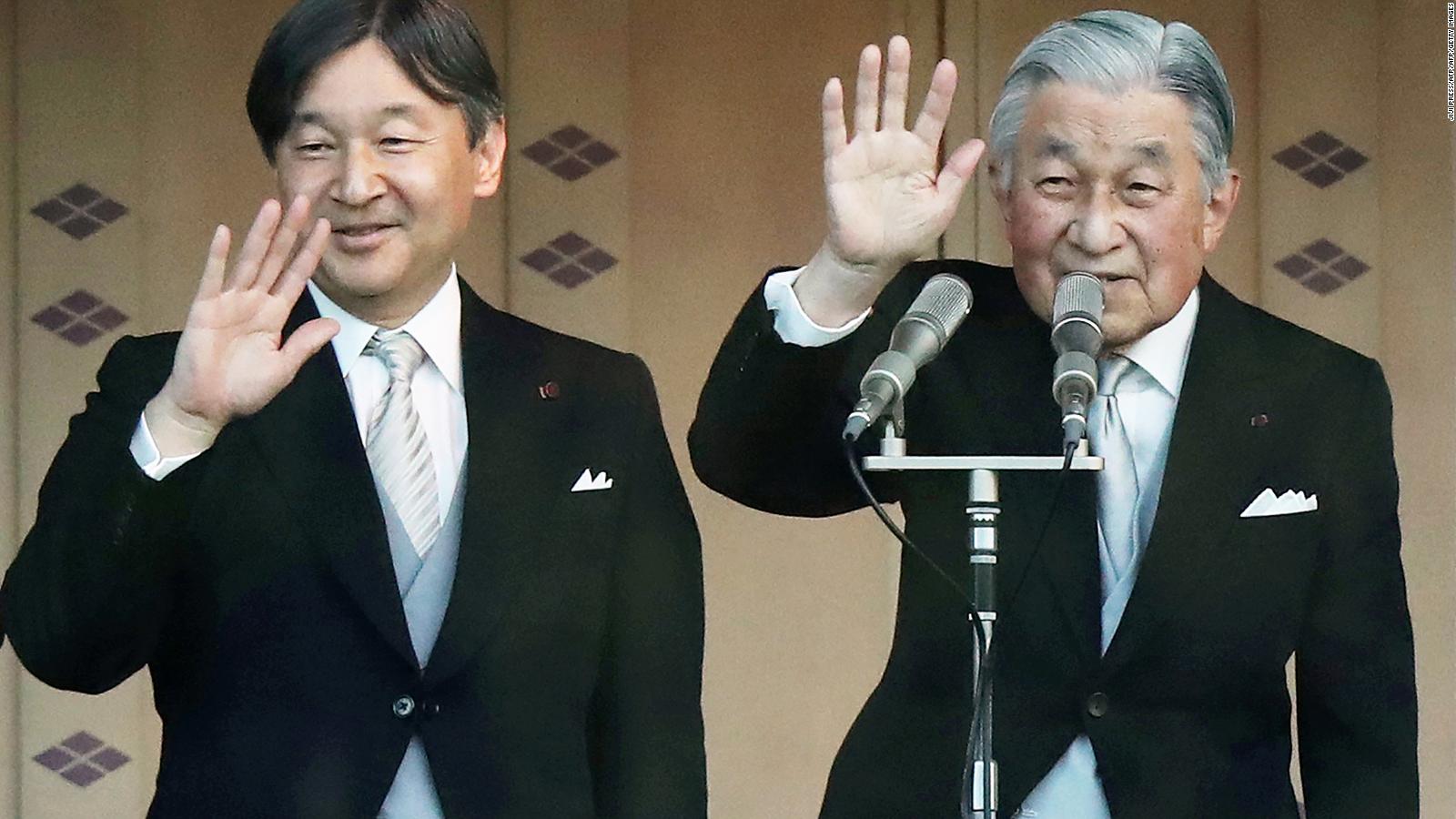 Japan's Emperor Akihito and his son, Crown Prince Naruhito wave to the crowd during the New Year's greeting ceremony at the Imperial Palace in Tokyo on January 2, 2019.