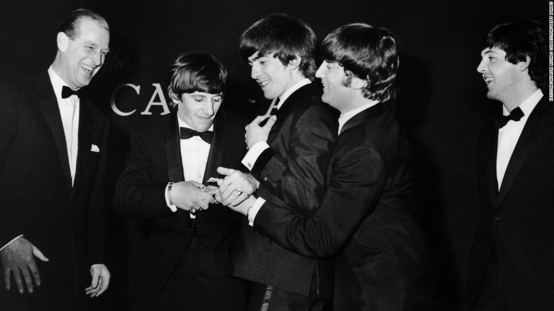 Prince Philip laughs as the Beatles fight over the Carl Alan Award he presented to the band in March 1964.