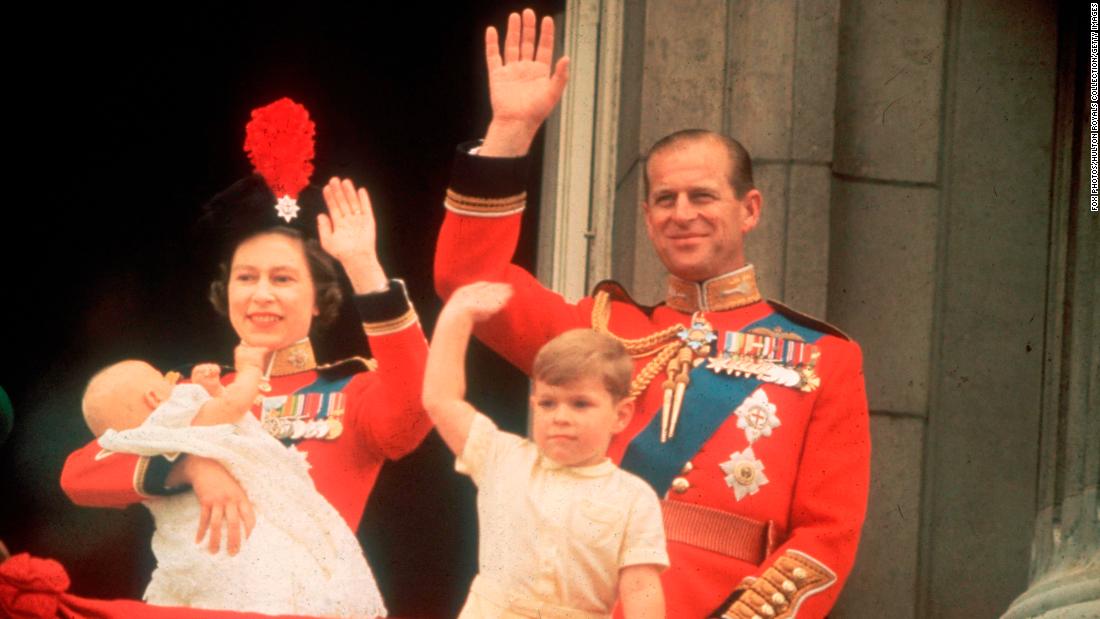 The Queen and Prince Philip, accompanied by sons Prince Andrew and Prince Edward, wave from a Buckingham Palace balcony during a parade in June 1964.