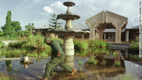On September 15, 2000, a soldier crosses a muddy spring in front of the court of Moboth Cesé Zeko in the Gombolite, Congo. Three large courtyards of Gad'ol were plundered several times. 