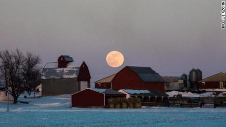   Wolf moon on farm buildings near Olin, Iowa. 