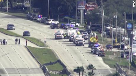 A large number police vehicles and ambulances respond to the SunTrust bank in Sebring, Florida.