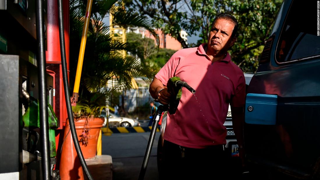A man pumps fuel at a gas station in Caracas on January 29. A day earlier, the United States announced sanctions against Venezuela&#39;s state oil company, Petroleos de Venezuela, S.A.