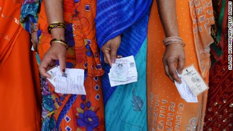 Indian voters stand outside of a polling booth during the last national election in 2014.