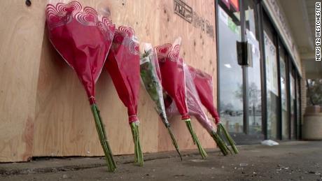 Flowers were deposited outside the 7-Eleven where the incident occurred.