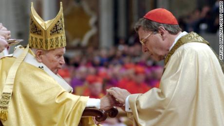 Pope John Paul II (L) gives his cardinal ring to George Pell of Australia inside St Peter Basilica 22 October, 2003, at the Vatican. 