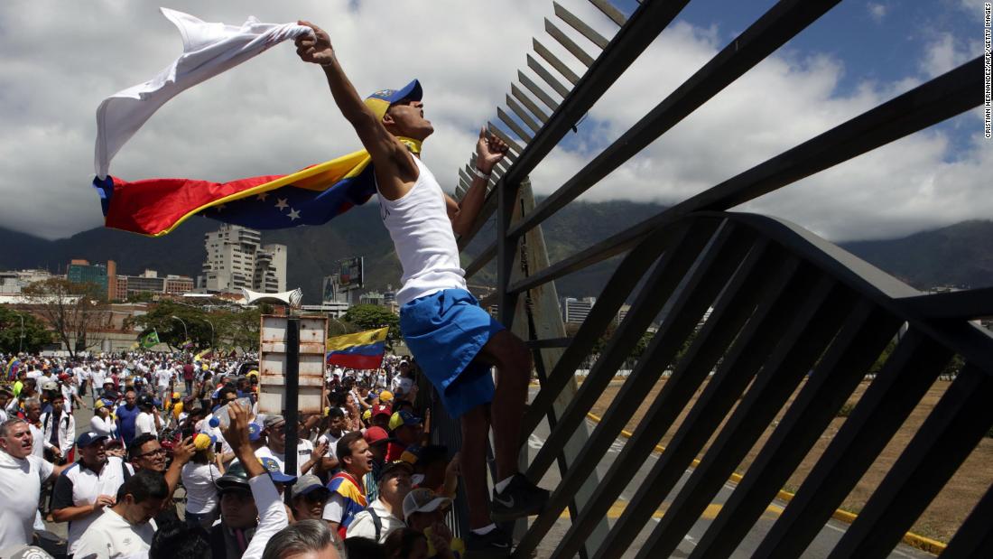 Guaido supporters take part in a march in Caracas on February 23. Venezuelan security forces fired tear gas and rubber bullets to disperse a crowd demanding to cross the Venezuela-Colombia border, which was ordered closed by Maduro.