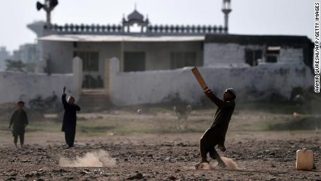 Afghan children play cricket at a refugee camp in Islamabad in October 2018.