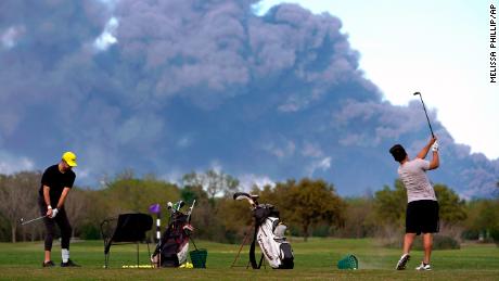 Even with a huge fire burning nearby, these golfers were SO worried.