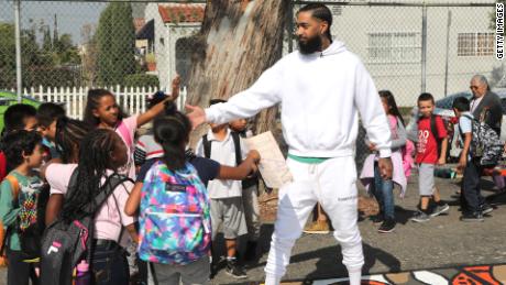 Nipsey Hussle greets the kids at a community event in Los Angeles in October.