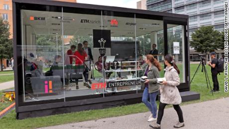 Students working in a glass cube on the campus of the Massachusetts Institute of Technology in 2018. The university suspends its ties with Huawei and ZTE.