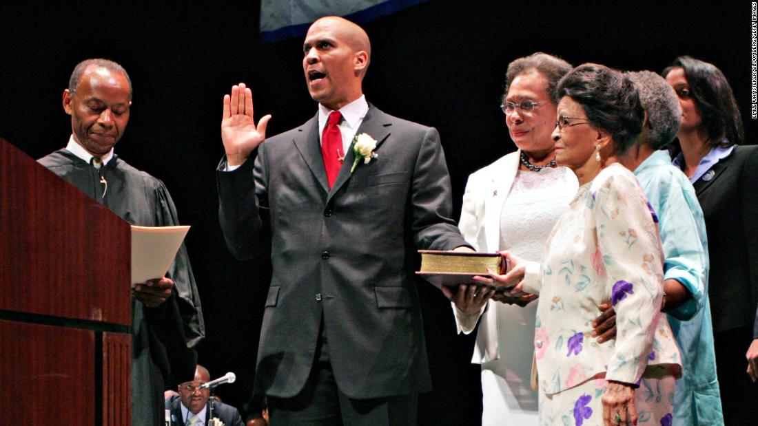 Booker takes the oath of office in July 2006. Next to him, holding the Bible, is his mother, Carolyn. Also holding the Bible in the foreground is Booker&#39;s grandmother, Adeline Jordan.