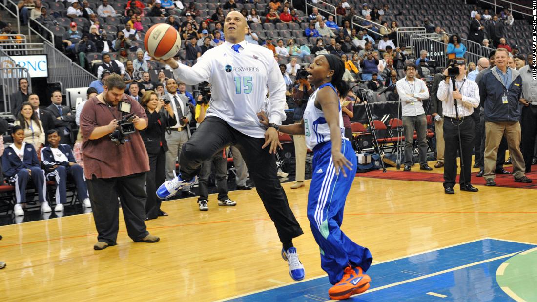 Booker plays a game of one-on-one with pro basketball player Cappie Pondexter in May 2011.