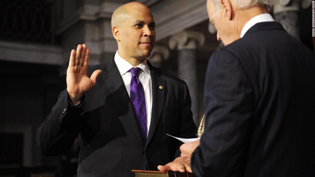 Booker takes the oath of office from Vice President Joe Biden during a ceremonial swearing-in at the US Capitol.