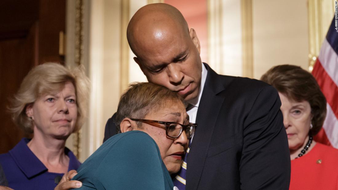During a news conference in June 2016, Booker embraces the Rev. Sharon Risher, a clinical trauma chaplain who lost her mother and two cousins in a church shooting in Charleston, South Carolina. Democratic senators were calling for gun-control legislation after a mass shooting at an Orlando nightclub.
