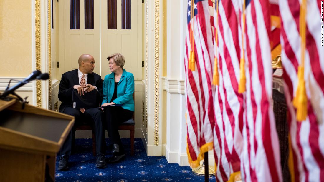 Booker and US Sen. Elizabeth Warren talk before the start of a July 2017 news conference that introduced the Dignity for Incarcerated Women Act.
