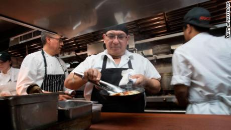 Chef Jacinto Guadarrama prepares dishes at Gotham Bar and Grill in New York, where hourly wages have gone up along with the city&#39;s minimum wage, to $15 as of the end of December.