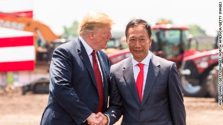 On June 28, 2018 in Mt Pleasant, Wisconsin, US President Donald Trump shakes hands with Foxconn President Terry Gou.