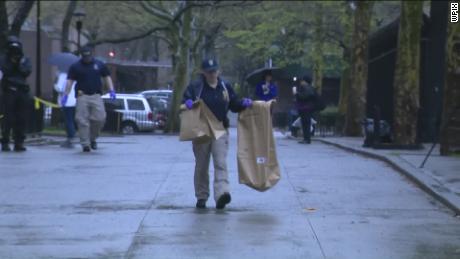 Police technicians remove bags of alleged evidence from crime scenes in Brooklyn. 