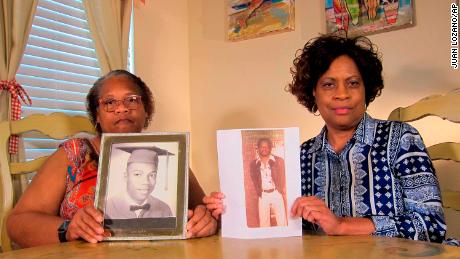 Louvon Byrd, left, and Mylinda Byrd Washington post photos of their brother who died earlier this month. 