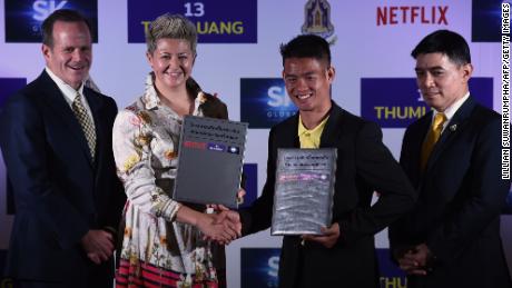 Erika North, director of Netflix's international originals, shakes hands with Ekkapol Chantawong, the group's coach 