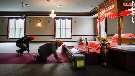 Jasminder Singh, chairman of the executive committee of a Sikh temple in West Chester Township, left, led a temple prayer service for victims of the shooting on Monday.