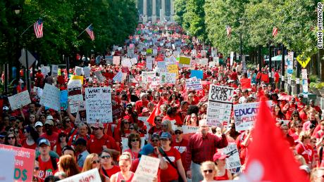 Thousands of teachers and other North Carolina school staff parade Wednesday in Raleigh. 