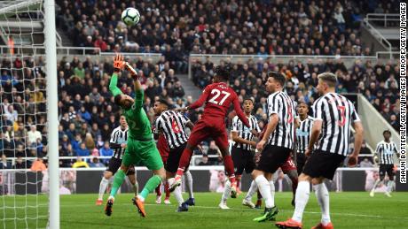 Divock Origi heads home his side&#39;s winner in the 3-2 victory at Newcastle.